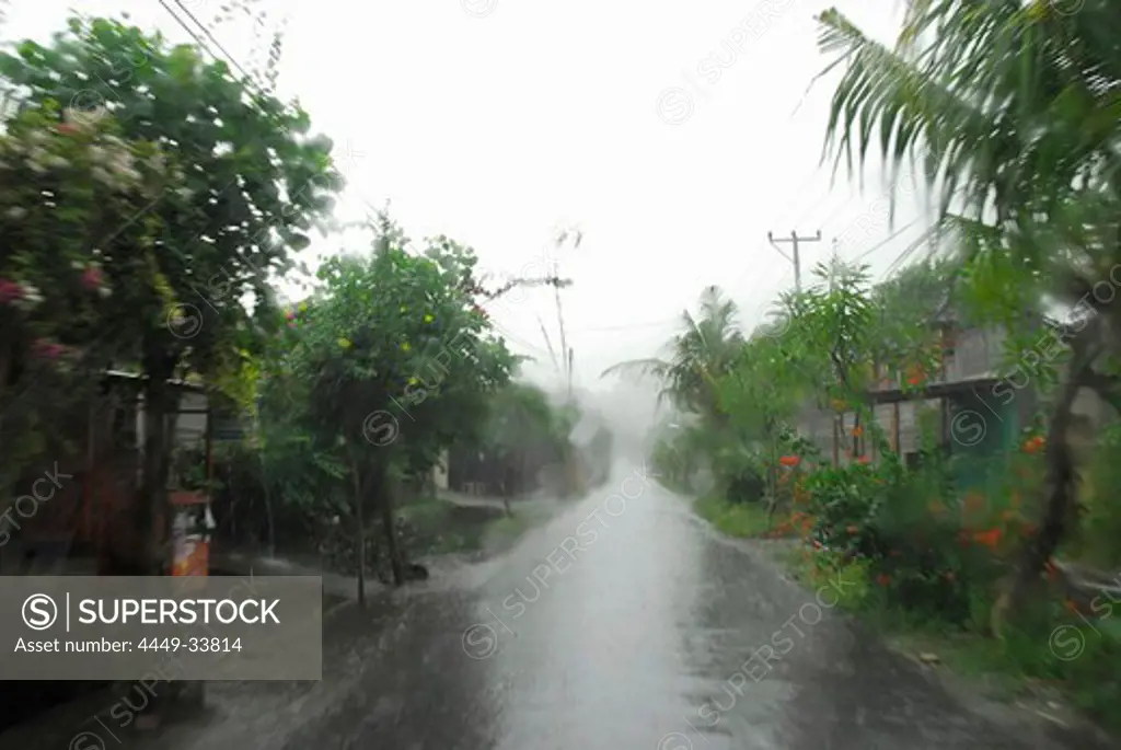 Empty village street in the rain, North Bali, Indonesia, Asia
