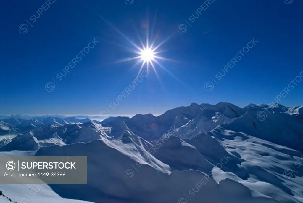 View at snow covered mountain range under blue sky, Alps, South Tyrol, Italy, Europe