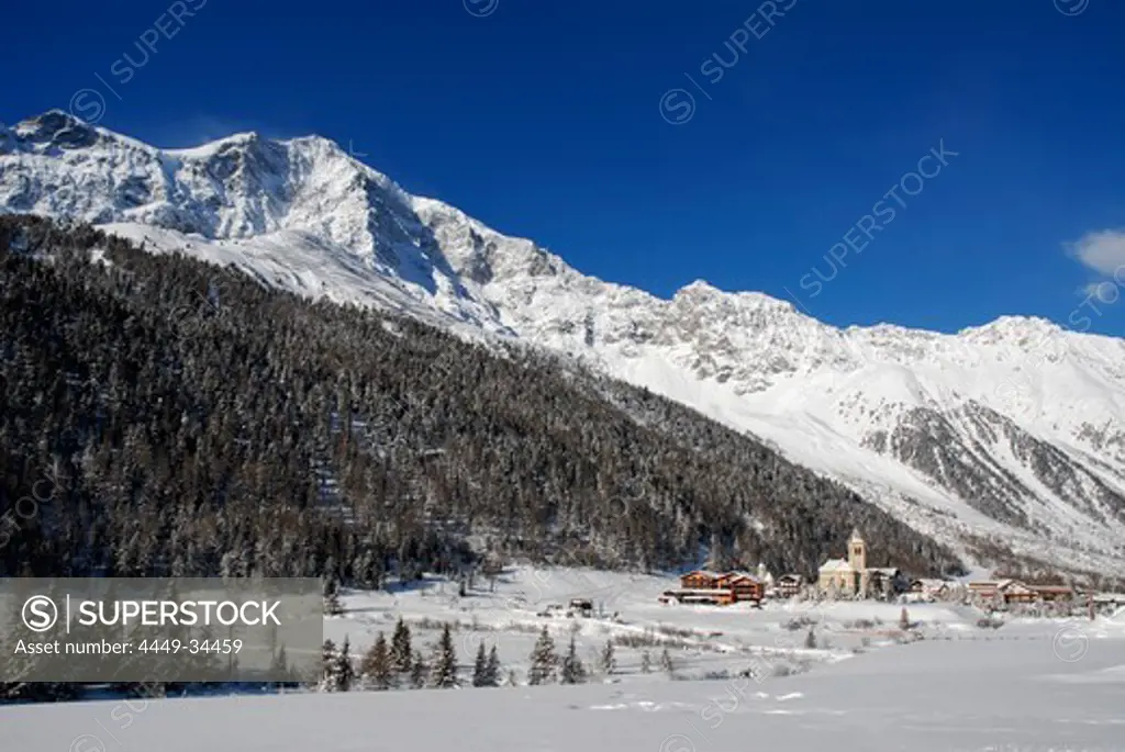 Village at snow covered valley under blue sky, Sulden, Val Venosta, South Tyrol, Italy, Europe
