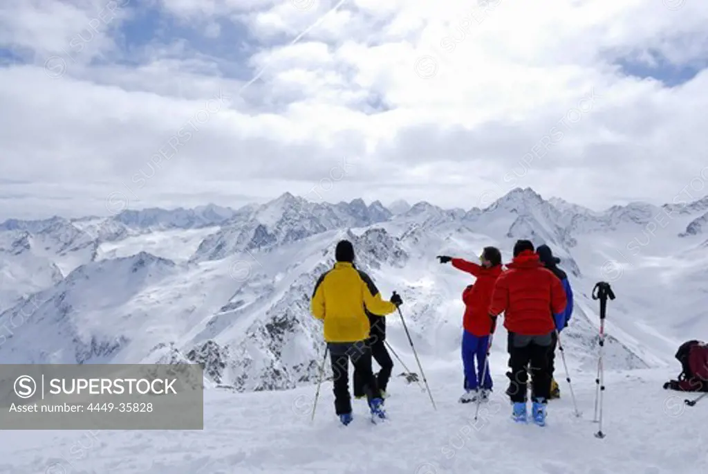 Group of backcountry skiers resting on summit of Lamsenspitze, Sellrain, Stubai range, Tyrol, Austria