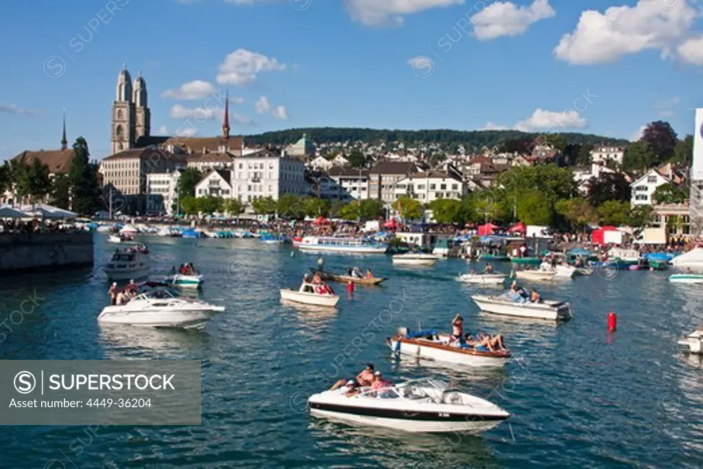 Zurich street parade weekend in summer, party boats on river Limmat, background Grossmunster, Zurich, Switzerland