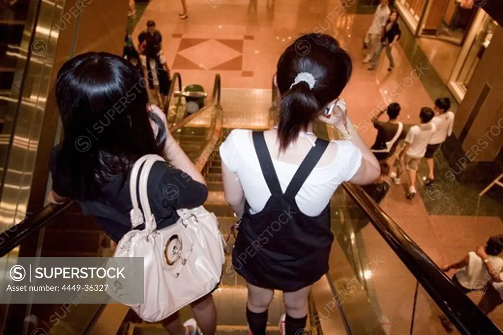 Modern asian girls on shopping trip in Ngee Ann City, Takashimaya shopping center, Orchard road, shopping zone, Singapur Aisia