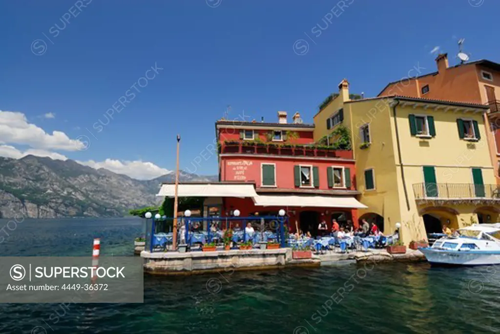 Restaurant at lakeshore, Malcesine, lake Garda, Veneto, Italy