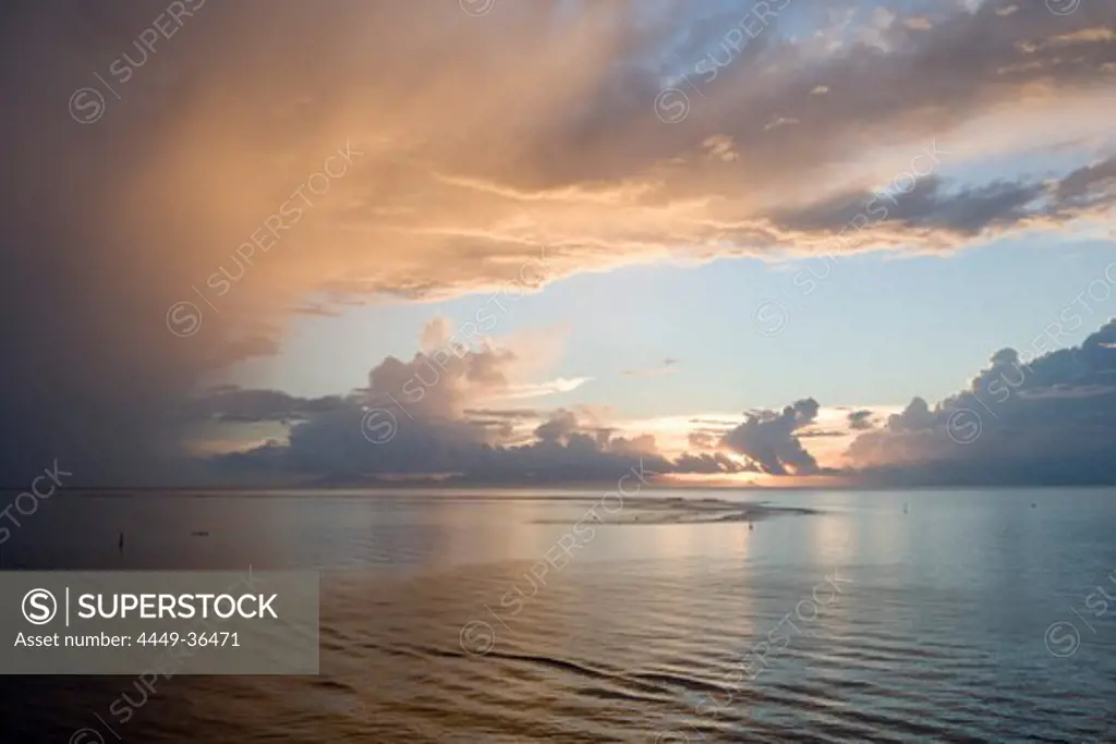 Thunderclouds above the ocean at sunset, Huahine, Society Islands, French Polynesia, South Pacific, Oceania