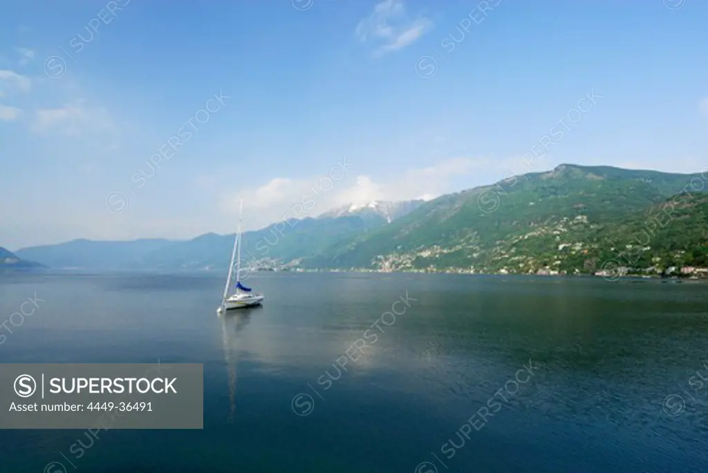 Sailing boat anchored at lake Maggiore with Gridone and Pizzo Leone in the background, Ascona, lake Maggiore, Lago Maggiore, Ticino, Switzerland