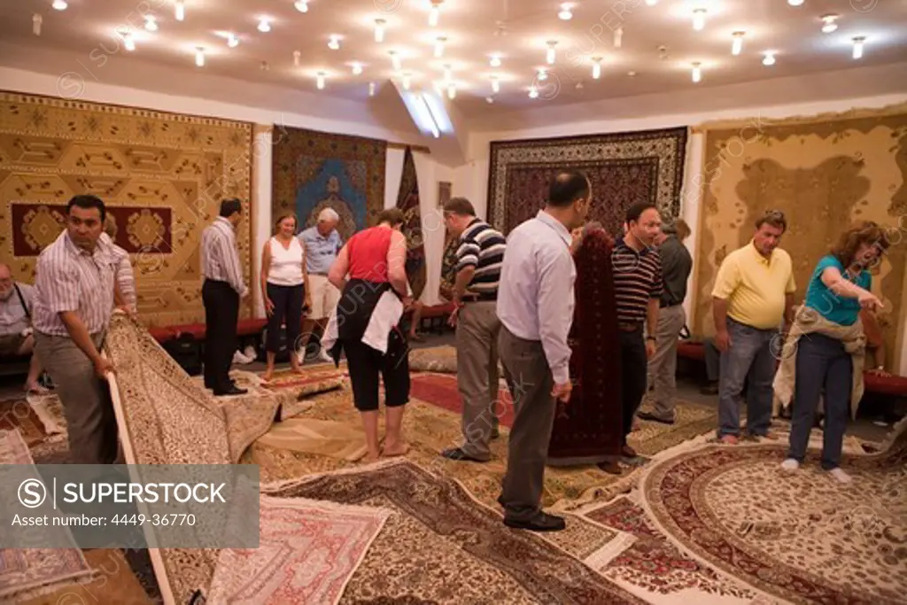 People looking at carpets at a Rug Factory, Dalyan, Turkey, Europe
