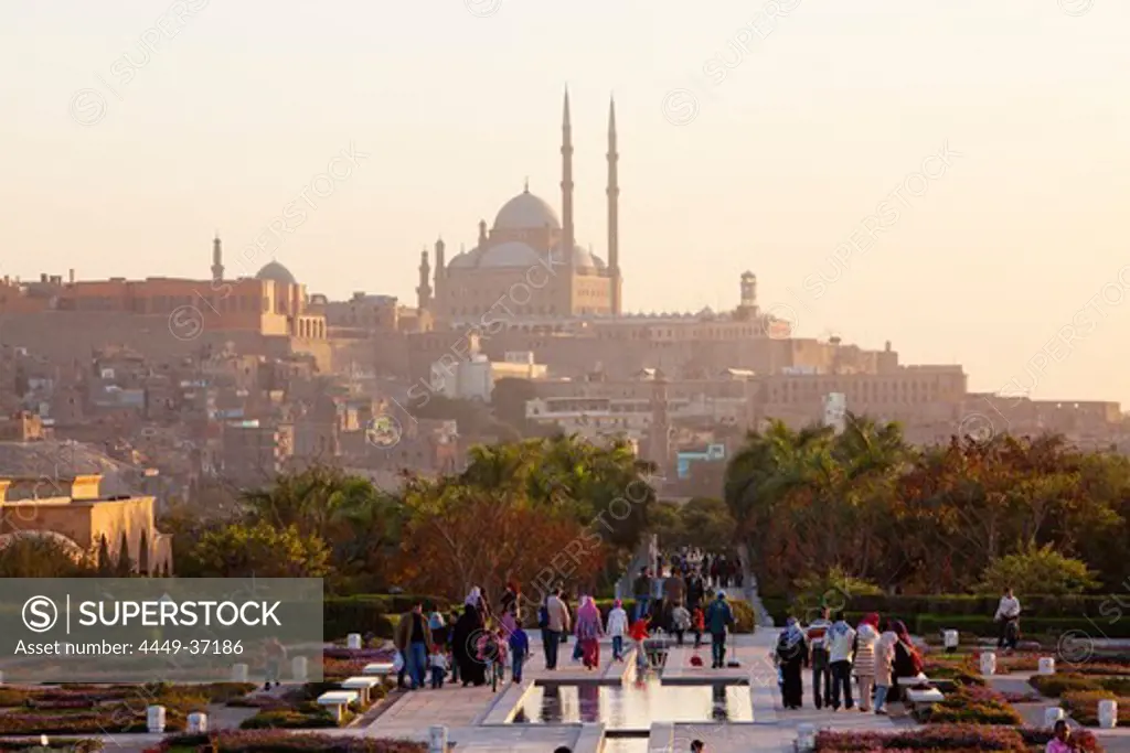 People strolling at Al Azhar Park, in the background the citadel with the mosque of Muhammad Ali, Cairo, Egypt, Africa