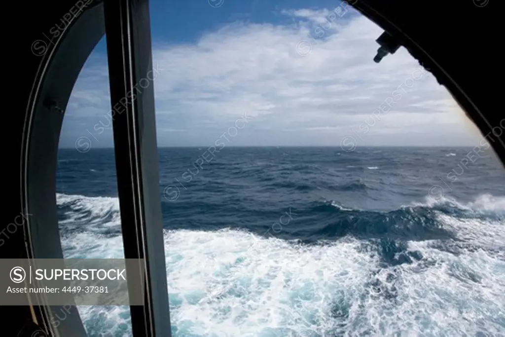 View of the Atlantic ocean and waves through a porthole, Cruise liner Queen Mary 2