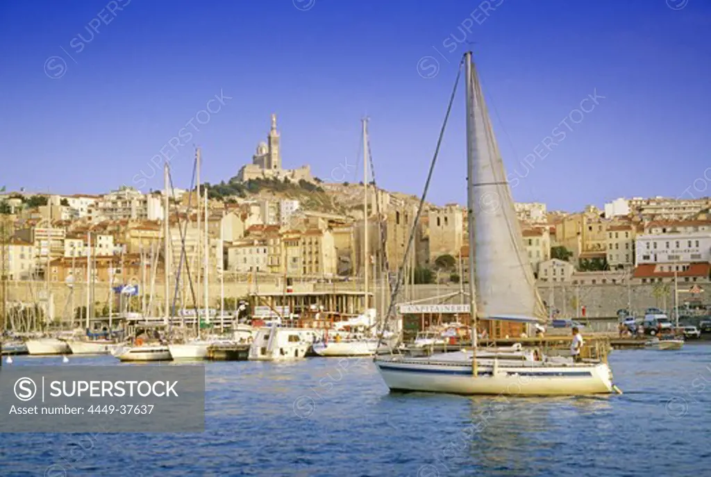 Sailing boats at Vieux Port harbour in front of church Notre-Dame-de-la-Garde, Marseille, Provence, France, Europe