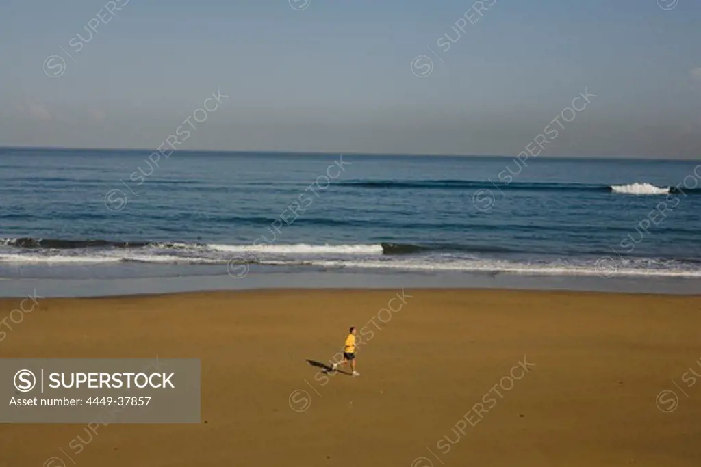 Lonesome jogger on the beach, Playa de las Canteras, Las Palmas de Gran Canaria, Gran Canaria, Canary Islands, Spain, Europe