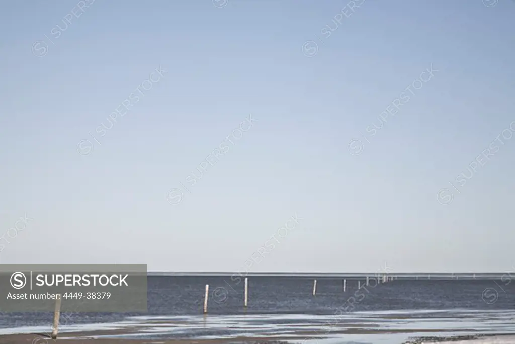 Wodden piles at low tide, St Peter Ording, Wadden Sea National Park, Schleswig-Holstein, Germany