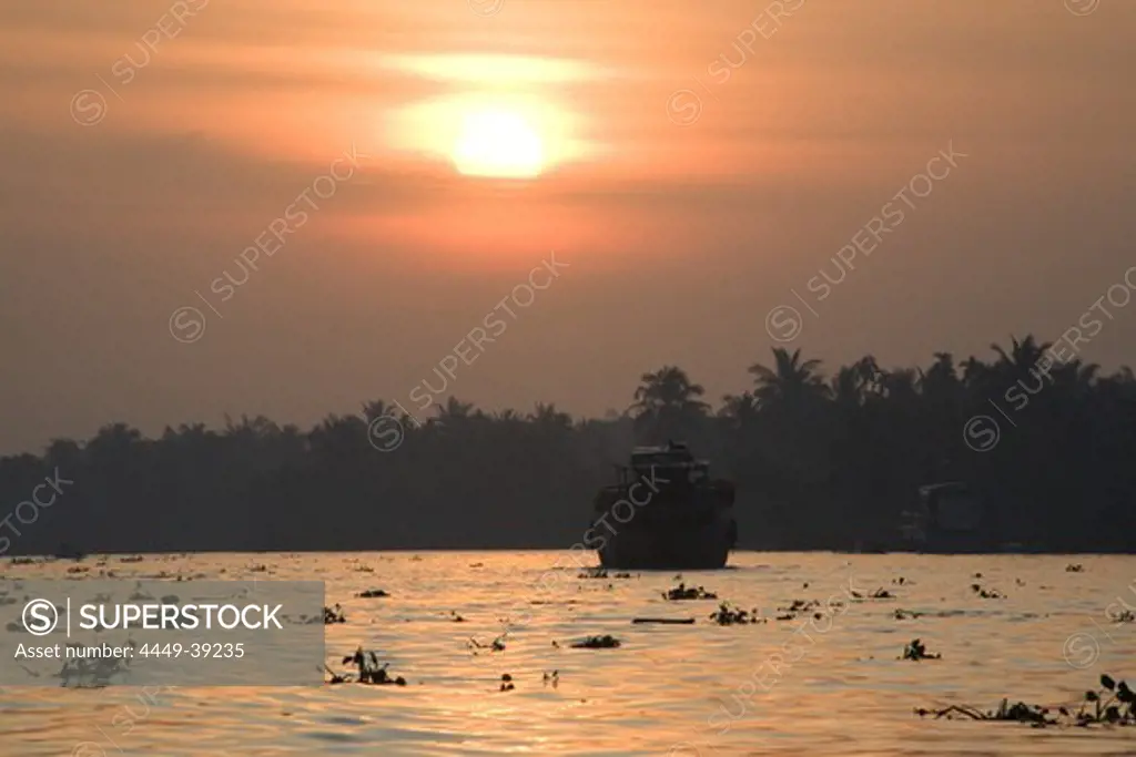 Ship on the Mekong River at sunrise, Mekong Delta, Can Tho Province, Vietnam, Asia