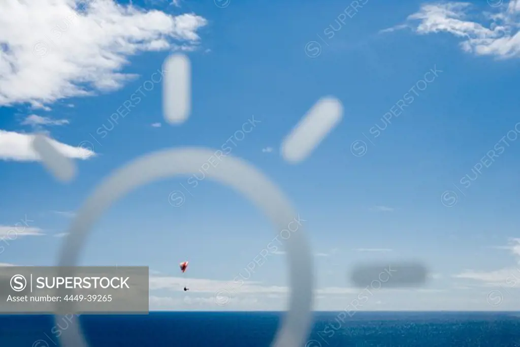 Paraglider viewed through the window of the Golden Residence Hotel, Funchal, Madeira, Portugal