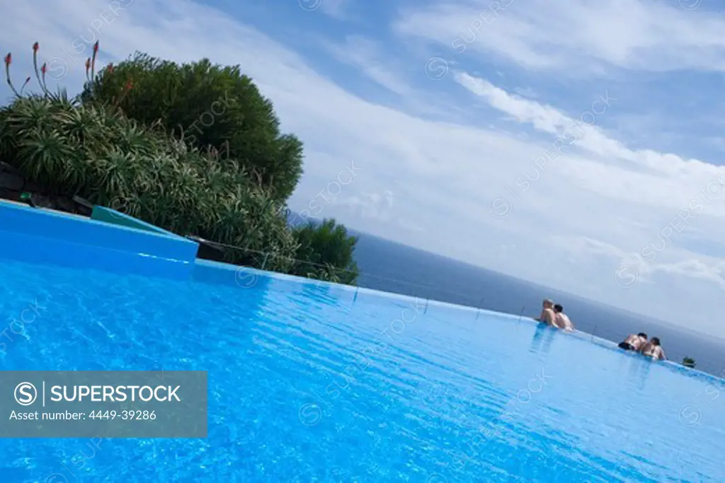 Two couples in the outdoor pool at Estalagem da Ponta do Sol Design Hotel, Ponta do Sol, Madeira, Portugal