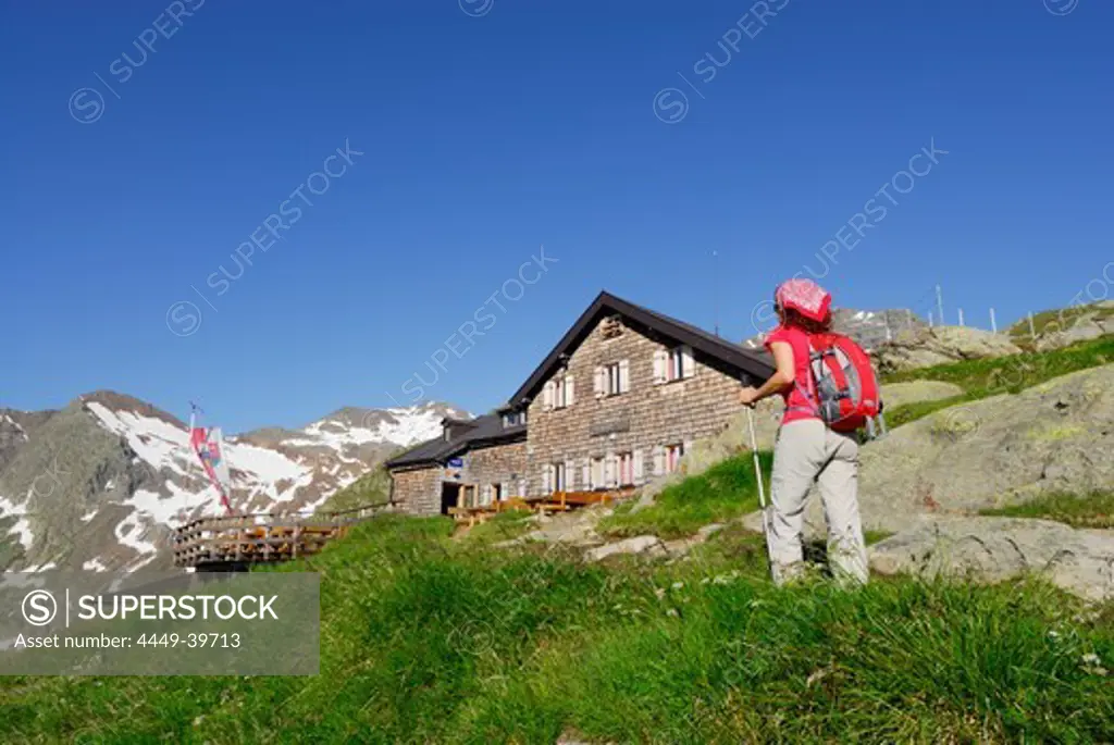 Female hiker arriving Magdeburg hut, Stubai Alps, Trentino-Alto Adige/South Tyrol, Italy