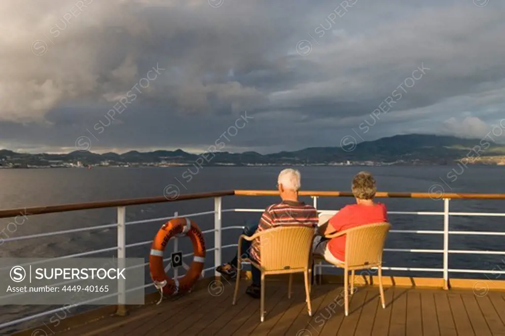 Couple oadmiring the view from the Cruiseship MS Delphin Voyager, Ponta Delgada, Sao Miguel Island, Azores, Portugal, Europe