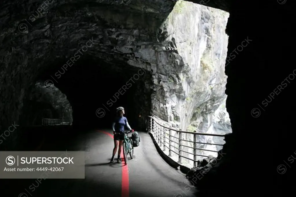Cyclist in a cave of the Taroko gorge at Taroko National Park, Tienhsiang, Tianxiang, Republic of China, Taiwan, Asia