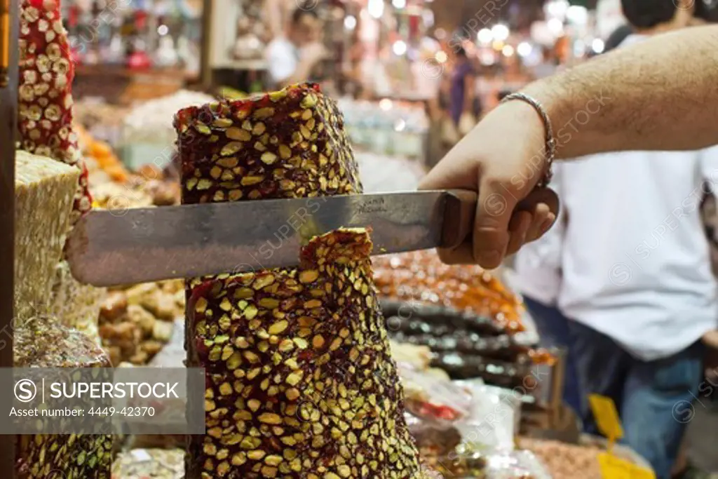 slicing Turkish sweets, close-up, Egyptian Bazaar, Istanbul, Turkey