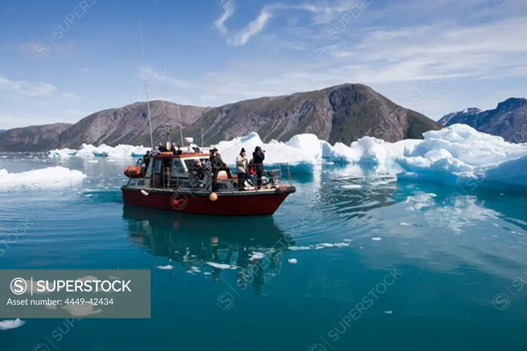 Excursion boat in front of iceberg at Qooroq Fjord, Narsarsuaq, Kitaa, Greenland