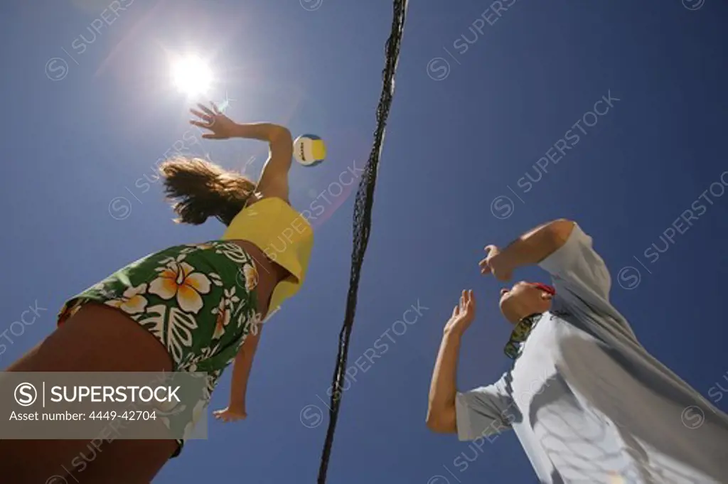 Two people playing beach volleyball, view from below, Mallorca, Balearic Islands, Spain