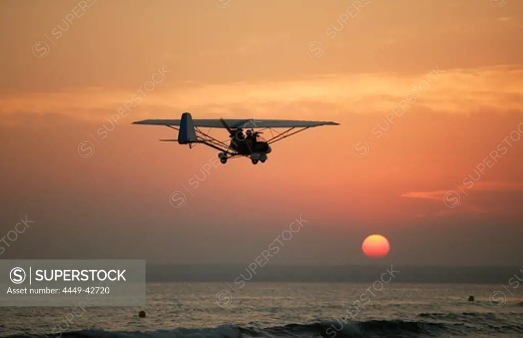 Ultralight plane flying over the beach of Es Trenc, Mallorca, Balearic Islands, Spain