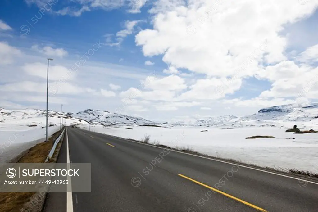 Country road through the snow covered Roldalsfjellet, Hodaland, Norway, Scandinavia, Europe