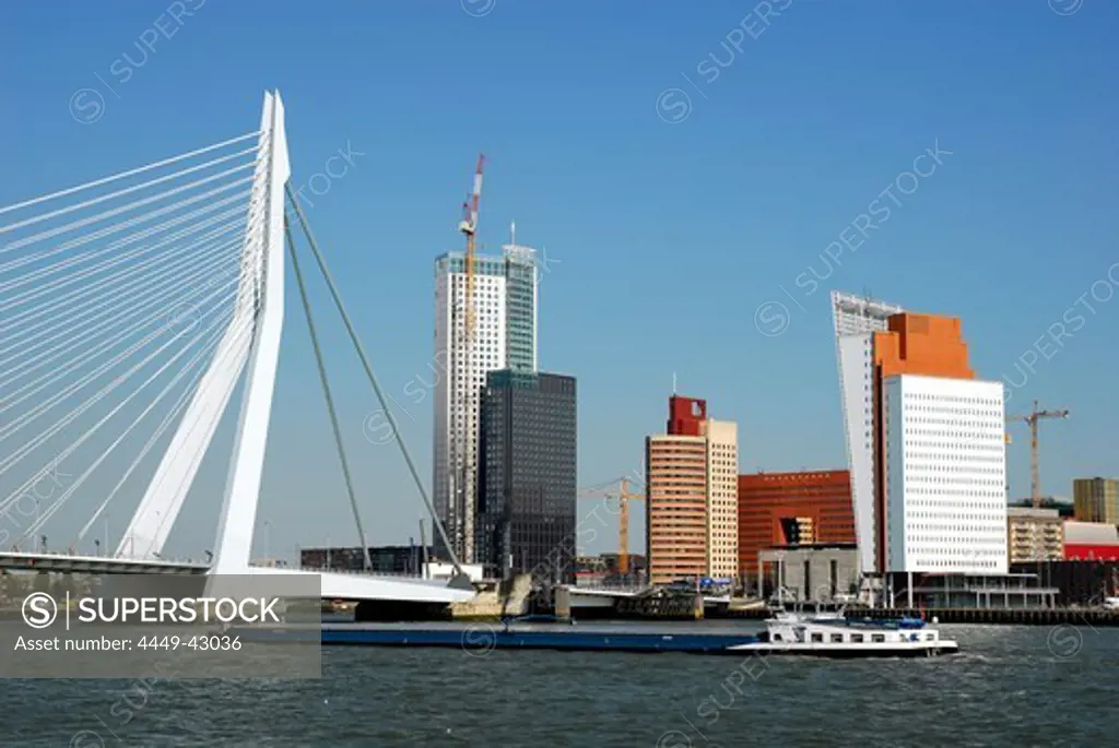 Freighter in front of Erasmusbrug, Erasmus bridge and modern architecture at the Wilhelminapier, Nieuwe Maas River, Rotterdam, Zuid-Holland, South-Holland, Nederland, the Netherlands, Europe