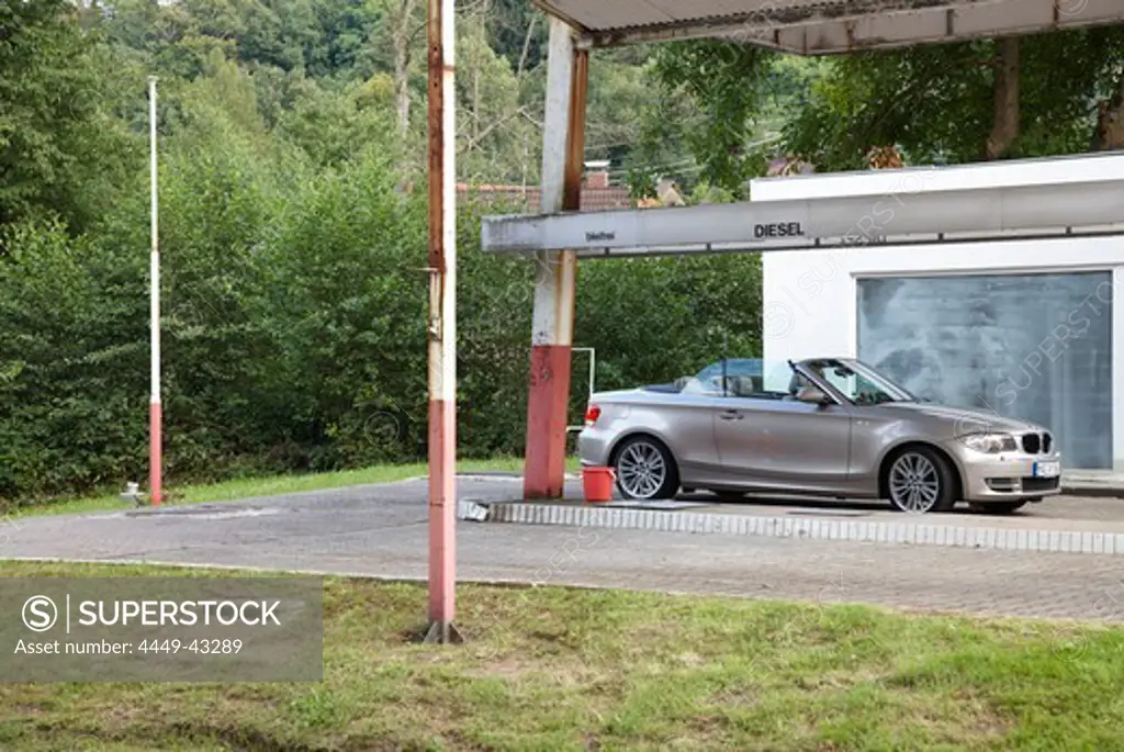 Convertible near closed gas station, Gernsbach, Black Forest, Baden-Wuerttemberg, Germany