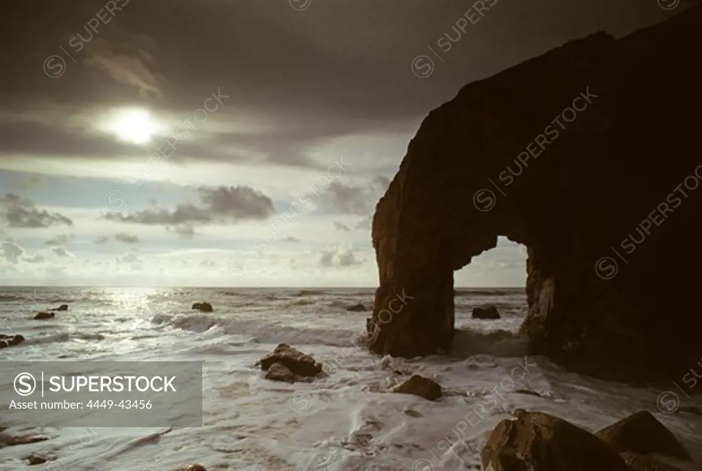 Gate in the rocks under clouded sky, Cote Sauvage, Quiberon, Brittany, France, Europe