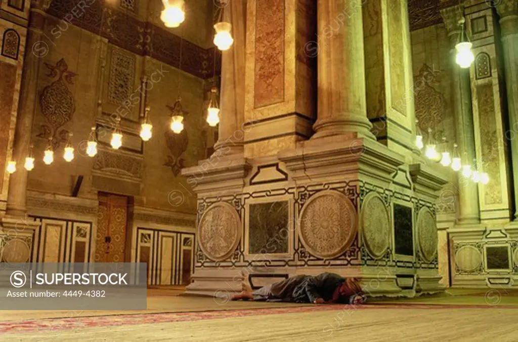 A man lying on the floor of Er Rifai Mosque, Cairo, Egypt