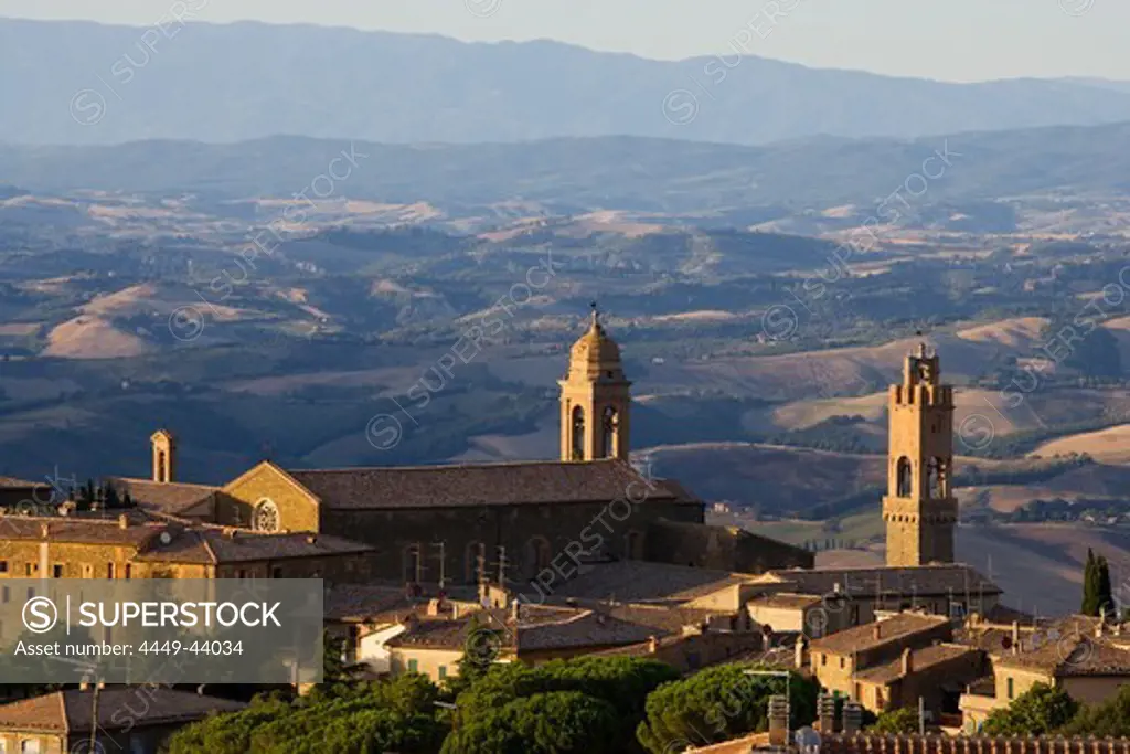 View over the roofs of Montalcino and the tower of the Palazzo Communale (r.) and the hills of Tuscany, Italy