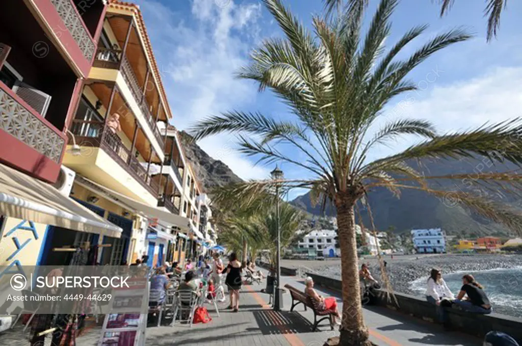 Tourists in cafes on the promenade, Playa de la Calera, Valle Gran Rey, Gomera, Canary Isles, Spain, Europe