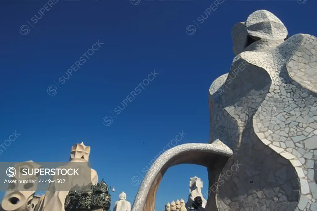 Sculptures on the roof of Casa Mila under blue sky, Barcelona, Spain, Europe
