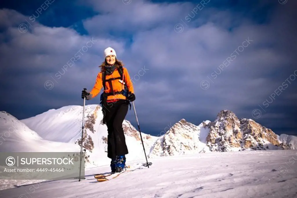 Woman backcountry skiing, Eisengabelspitze and Antonispitze in background, Col Bechei, Dolomites, Trentino-Alto Adige/Suedtirol, Italy