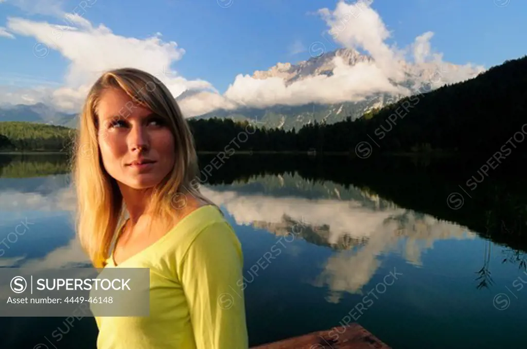 Young woman near lake Lautersee, Mittenwald, Werdenfelser Land, Upper Bavaria, Germany