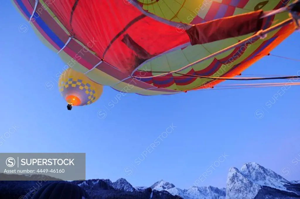 Two hot-air balloons flying one upon the other, Waxensteine in background, Garmisch-Partenkirchen, Wetterstein range, Bavarian alps, Upper Bavaria, Bavaria, Germany, Europe