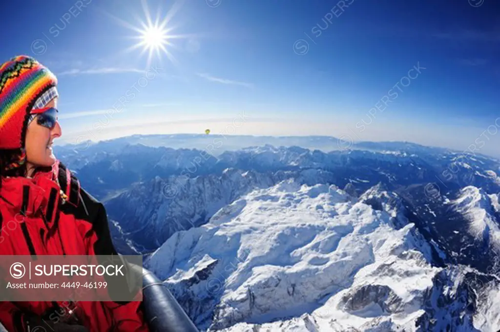 Woman in hot-air balloon enjoying view to Pala range in winter, aerial photo, Pala range, Dolomites, Venetia, Italy, Europe