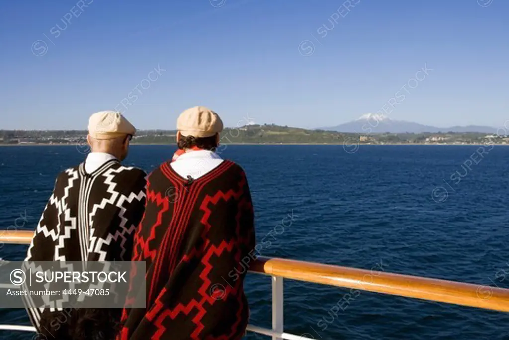 Passengers with South American parkas on deck of cruiseship MS Deutschland (Deilmann Cruises), Puerto Montt, Los Lagos, Patagonia, Chile, South America, America