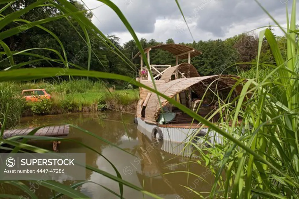 Houseboat and mini as garden art at a garden festival, Ippenburger Castle, Bad Essen, Lower Saxony, Germany
