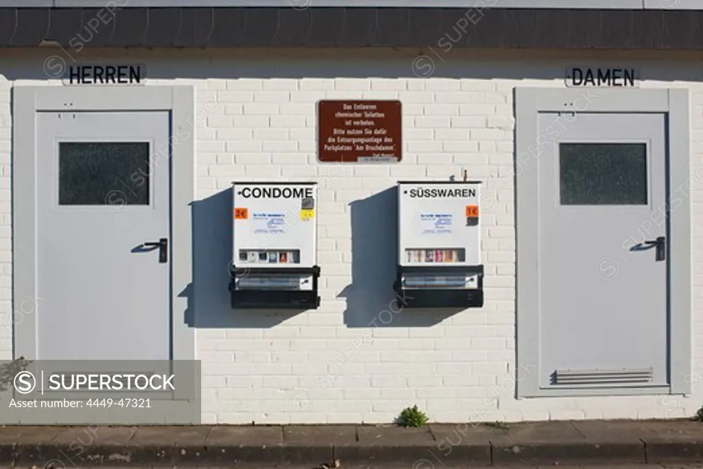 Sweets and condom vending machines on the wall of a toilet block, Steinhude, Lower Saxony, Germany