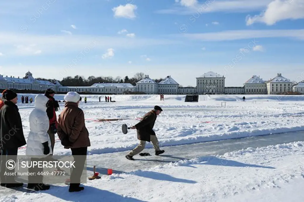 Group of people doing Bavarian curling, Nymphenburg castle in the background, Nymphenburg castle, Munich, Upper Bavaria, Bavaria, Germany