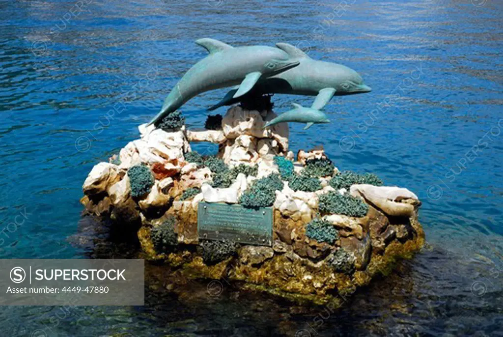 Dolphins, sculpture in the harbour, Megisti town on the Kastelorizo Island, Meis, Dodecanese Islands, Aegean, Mediterranean, Greece