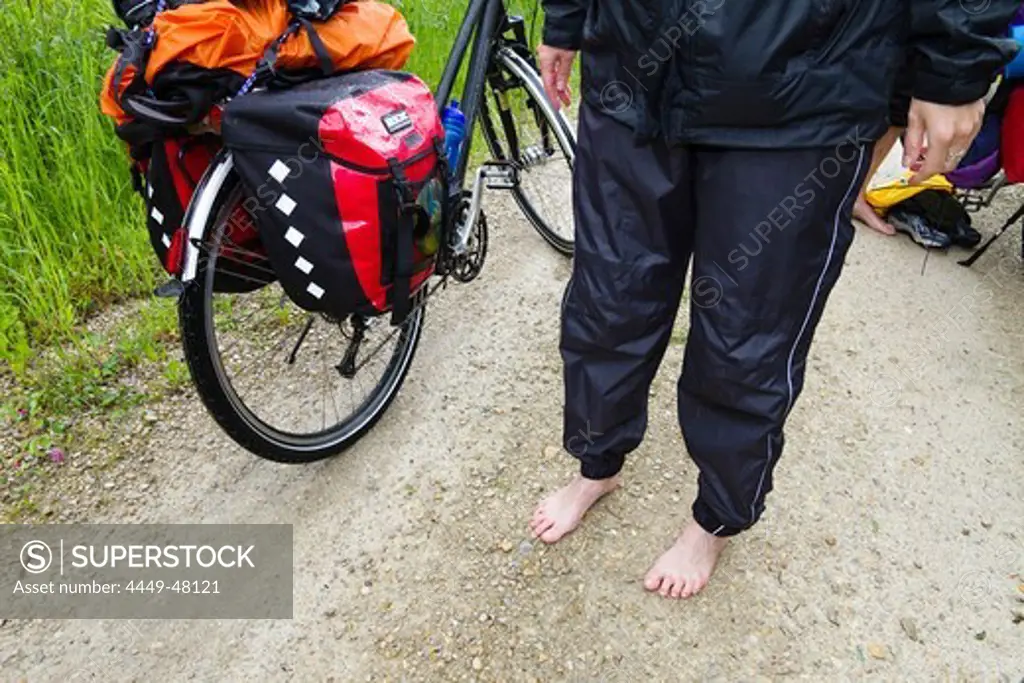 Wet cyclist, Isar Cycle Route, near Moosburg, Upper Bavaria, Germany