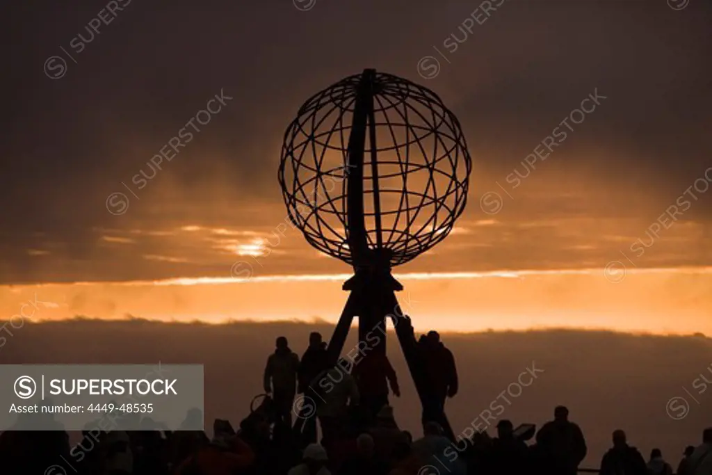 People at Nordkapp Globe Sculpture with Midnight Sun, North Cape, Finnmark, Norway, Europe