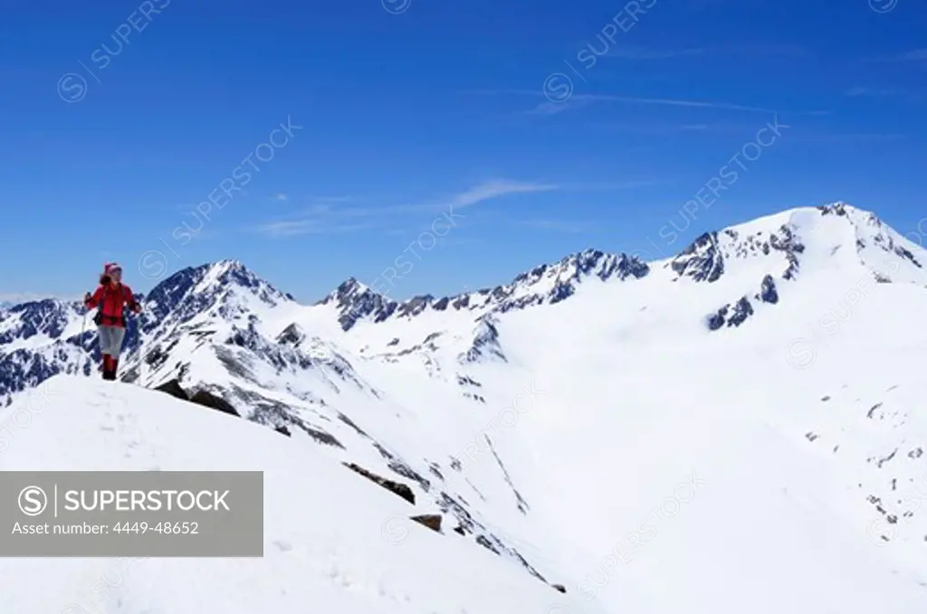 Woman ascending mountain Im Hinteren Eis, Weisskugel in background, Schnals valley, Oetztal Alps, Vinschgau, Trentino-Alto Adige/Suedtirol, Italy