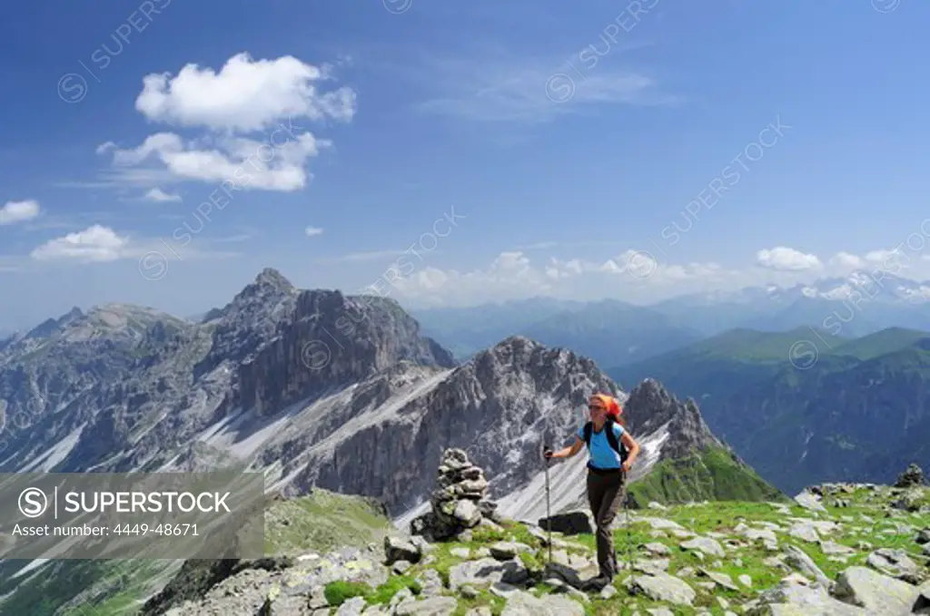 Woman ascending Habicht, Kalkwand and Kirchdachspitze in background, Gschnitz valley, Stubai Alps, Tyrol, Austria