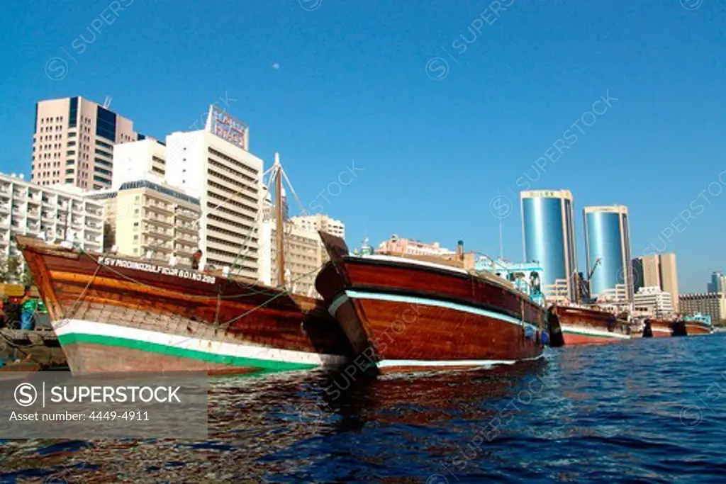 Dhow boats on Dubai Creek in front of modern high rise buildings, Dubai, UAE, United Arab Emirates, Middle East, Asia