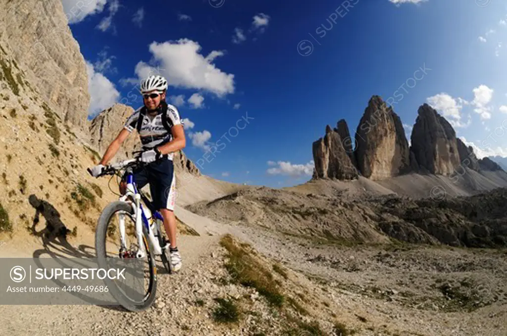 Cyclist Roland Stauder in front of the Drei Zinnen, Hochpuster valley, South Tyrol, Dolomites, Italy, Europe