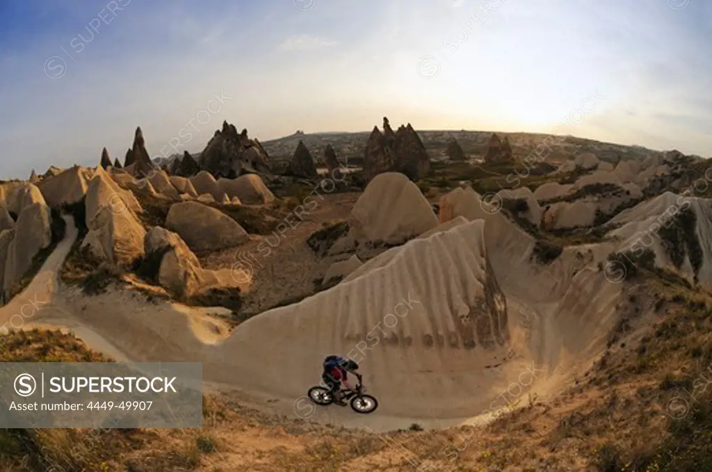 Mountain biker in the Devrent valley, Goereme valley, Goereme, Cappadocia, Turkey