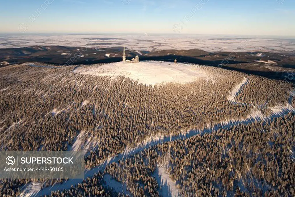Aerial view above the snow covered Brocken mountain in Harz National Park with transmitter site, Saxony-Anhalt, Germany